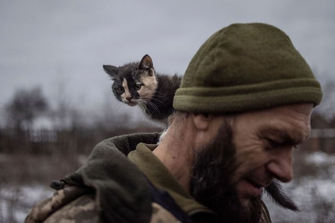 A cat sits on the shoulder of Ukrainian serviceman Mykyta of the 93rd separate mechanized brigade at a rest house near the front line in the Donetsk region, amid Russia’s