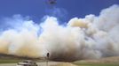 A helicopter flies down US highway 89 as smoke from the Wood Hollow fire fills the sky north of Fairview, Utah, June 26, 2012. More than 500 structures have been threatened by the Wood Hollow fire, forcing up to 1,500 people from homes. REUTERS/George Frey (UNITED STATES - Tags: ENVIRONMENT DISASTER TPX IMAGES OF THE DAY) Published: Čer. 26, 2012, 10:03 odp.