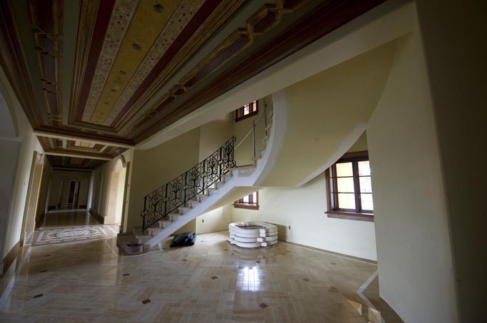 The staircase on a ground floor area of a for sale, $37 million dollar luxury home at One Pelican Hill Road North is seen in Newport Beach, California April 13, 2012. It has 17 bathrooms, a 17-car garage, marbled floors, gold leaf ceilings, a vineyard, horse stables, tennis courts and a lake - and occupies the largest parcel of residential real estate on southern California's exclusive Newport Coast. This empty, never-sold, soon-to-be-auctioned mega-mansion is a gaudy symbol of the runaway extravagance that gripped the top end of the U.S. real estate market before the housing crash of 2008. Once valued at $87 million, it could be sold for a quarter of that price at an auction next week. Picture taken April 13, 2012. REUTERS/Lori Shepler (UNITED STATES - Tags: BUSINESS REAL ESTATE)