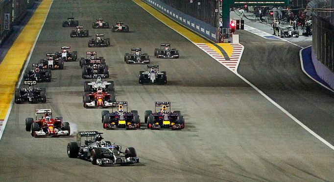 Mercedes Formula One driver Lewis Hamilton (front) of Britain leads the pack as team mate Nico Rosberg (top, R) of Germany starts from the pit lane following problems wit