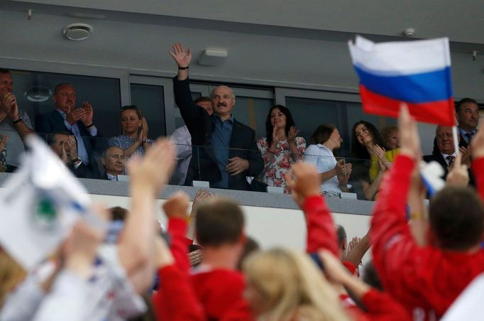 Belarus President Alexander Lukashenko (C) waves as he arrives to watch the men's ice hockey World Championship final game between Finland and Russia at Minsk Arena in Mi