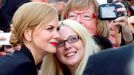 Nicole Kidman (L) poses for a photo with a fan as she arrives for the premiere of the film "The Railway Man