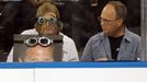 A fan watching the New York Rangers play the Boston Bruins from a front row seat gets a reaction from his neighbor during the second period of Game 3 of their NHL Eastern