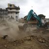 Excavator digs the rubble to search for the bodies after an earthquake hit, in Kathmandu, Nepal