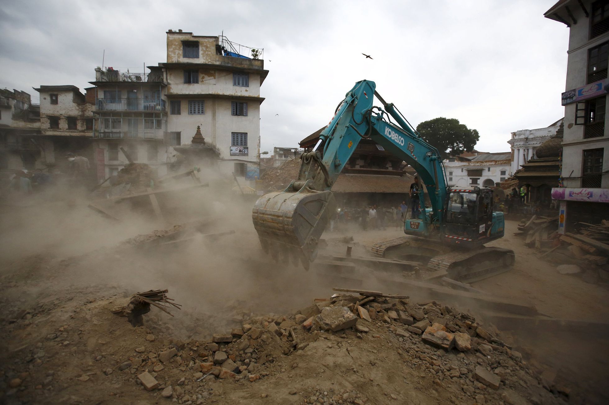 Excavator digs the rubble to search for the bodies after an earthquake hit, in Kathmandu, Nepal
