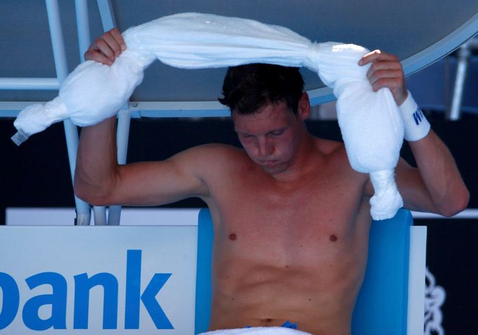 Tomas Berdych of Czech Republic holds an ice-packed towel during his men's singles match against Damir Dzumhur of Bosnia and Herzegovina at the Australian Open 2014