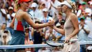 Caroline Wozniacki (R) of Denmark shakes hands with Maria Sharpova of Russia after defeating her at the 2014 U.S. Open tennis tournament in New York